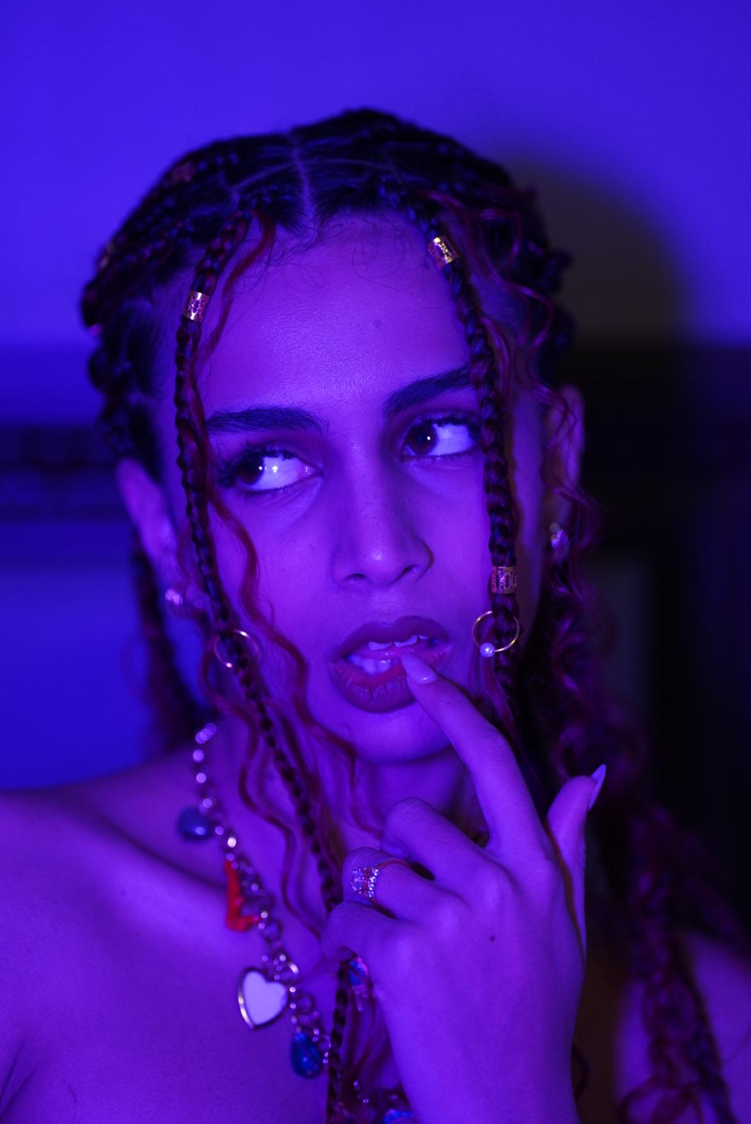 Portrait of Fartashia with braids in violet light