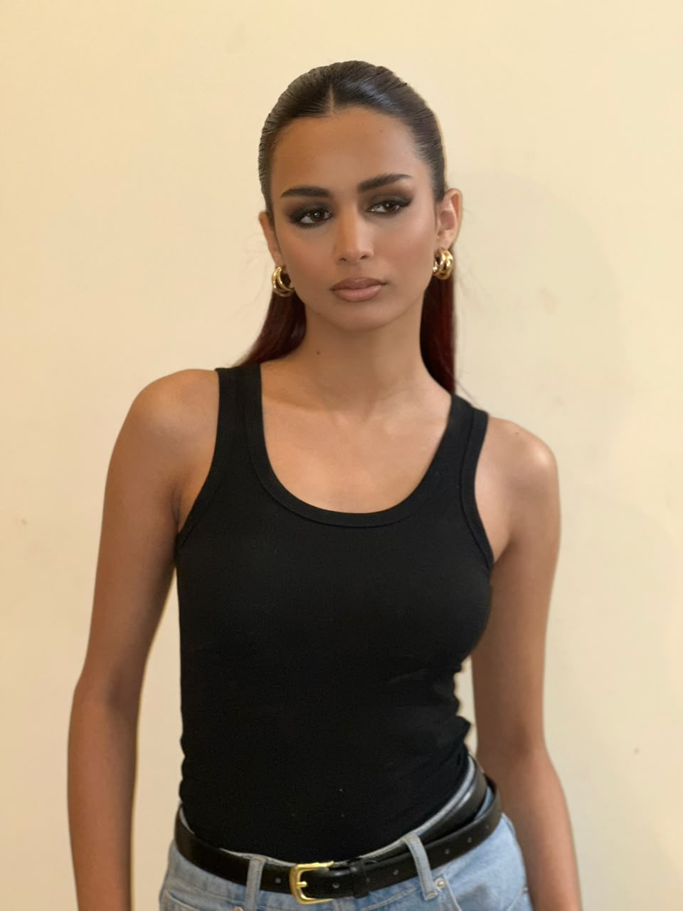 Fartashia with a sleek ponytail and black top